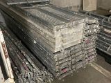 several pieces of metal are stacked on top of each other in a warehouse