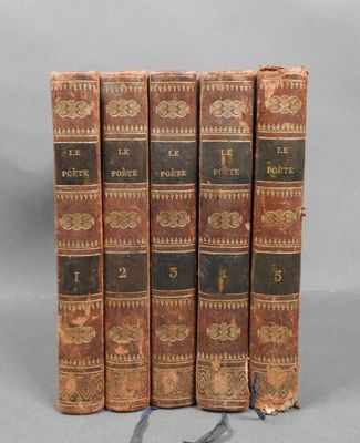 quatre vieux livres empilés les uns sur les autres sur une surface grise