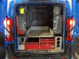 a blue van with a bed in the back of it