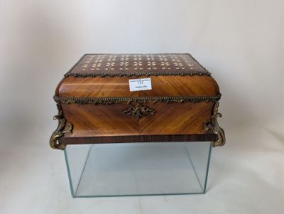 a small wooden box on a glass stand