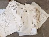 many drawings on the floor next to a pair of scissors