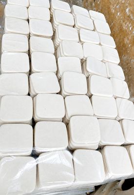 a pile of white containers sitting on top of a table