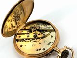 a gold pocket watch with a chain attached to it