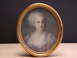 une vieille photo d'une femme en robe blanche dans un cadre doré