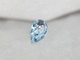 an image of a blue topazte stone on a white surface