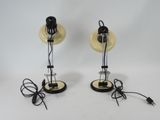 two black and white lamps on a white surface with wires