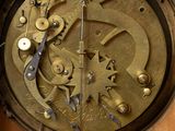 a close up of a clock that is on a wall