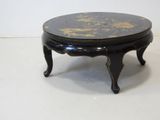 a small black table with a marble top on a white floor