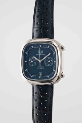 a close up of a watch with a blue face and black leather strap