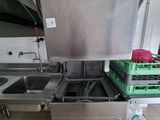a kitchen with a sink and a dishwasher in it