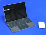 a laptop computer sitting next to a mouse on a blue table