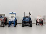 a row of toy tractors lined up on a white surface
