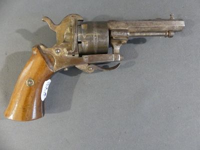 a gun that is sitting on a table with a tag on it