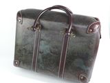 a brown leather briefcase sitting on a white surface