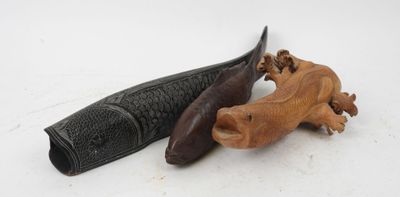 pair of carved wooden animal figurines on a white surface