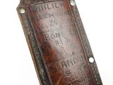 someone is holding a brown leather case with writing on it