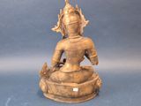 statue of a woman sitting on a pedestal with a bird on her shoulder