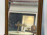 a mirror that is on a shelf above a table