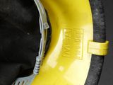 a close up of a yellow hard hat on a black surface