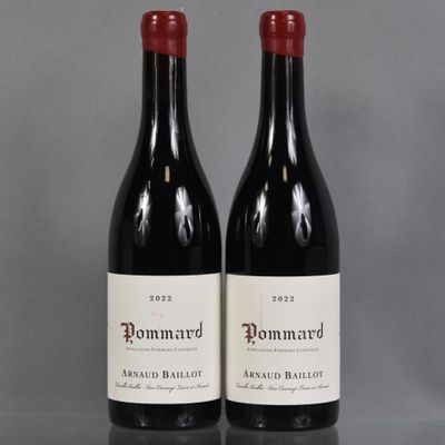 two bottles of red wine sitting next to each other on a table