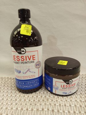 a bottle of liquid and a jar of toothpaste on a doily