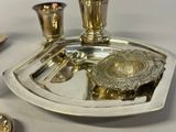a silver tray with a silver candle holder on it