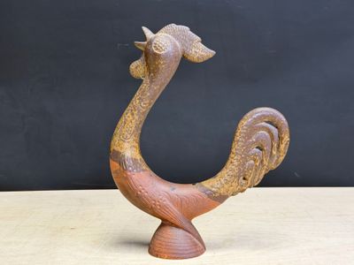 an image of a wooden sculpture of a bird on top of a table