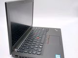 a laptop with a black keyboard on a white surface