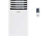 a white air conditioner sitting next to a remote control