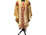 an image of a gold and red dress on a mannequin stand