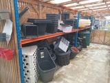 many bins and bins on the shelves in the yard