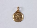 a close up of a gold coin on a white surface