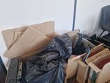 a pile of boxes and a chair in a room