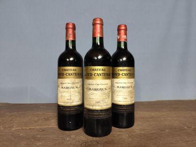 three bottles of wine sitting on top of a wooden table