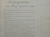 an old book with writing on it sitting on top of a table