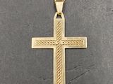 a gold cross pendant with a chain on a black surface