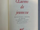 an open book with red writing on it sitting on a table