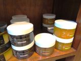 many jars of different types of skin care products on a shelf