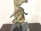 statue of an elephant on a marble block on a wooden table