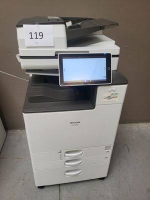 a photo of a multi - function printer with a tablet on top of it