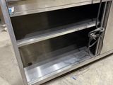 a stainless steel cabinet with shelves on the floor