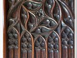 carved wood panel with a bird and flowers on it