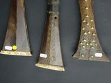 three different types of wooden instruments are displayed on a black surface
