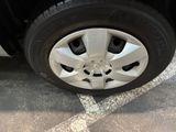 a close up of a tire on a car in a parking lot