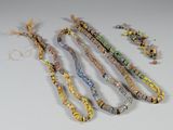 several pieces of jewelry are laid out on a white surface