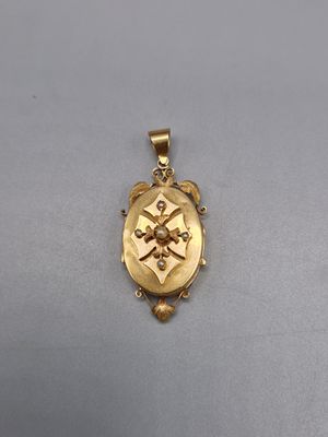 un fermoir en or orné d'une croix sur le devant