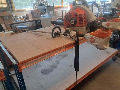a picture of a workbench with a chainsaw on top of it