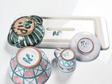 a tray with a tea pot and two cups on it