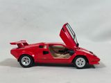a close up of a red toy car with open doors