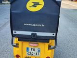 a yellow and black scooter parked on the side of the road